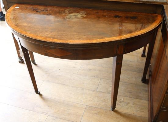 A George III mahogany demi-lune folding dining table W.132cm